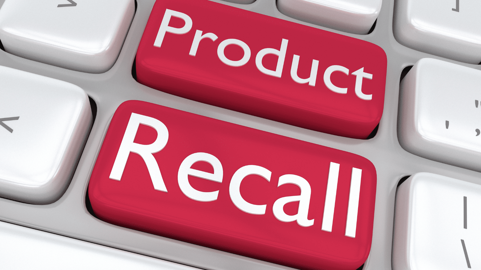 Two red keyboard keys labeled Product and Recall are shown close up, emphasizing the concept of a product recall. The keys stand out against standard white keyboard buttons.
