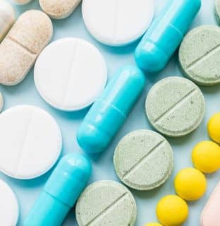 lines of tablets, pills and capsules in tans, white, blue and yellow