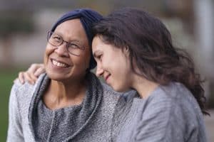 girl and a middle aged woman hugging each other and smiling