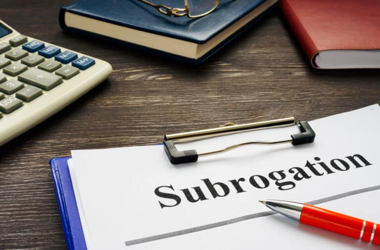 Documents about Subrogation with notepad and glasses