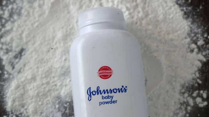 talcum powder bottle laying on pile of talc
