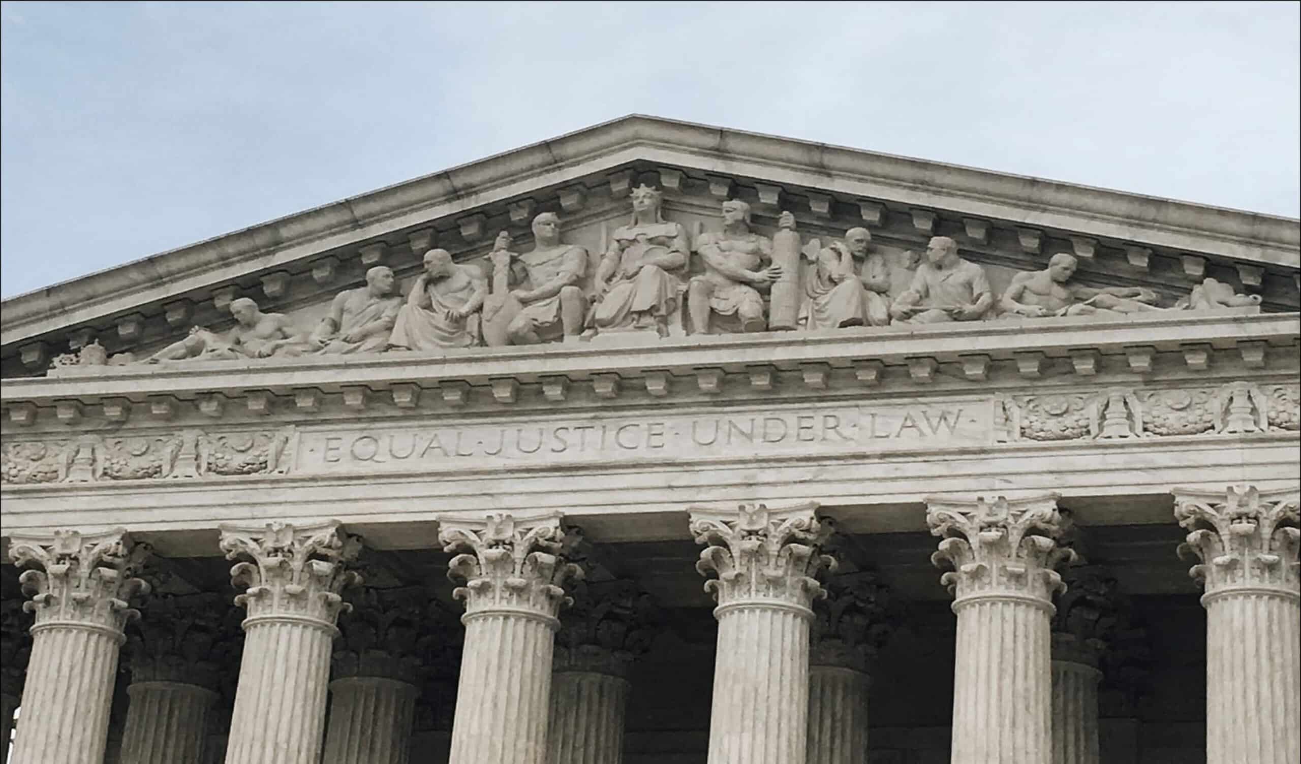 The facade of the U.S. Supreme Court building, featuring Corinthian columns and a sculpted frieze above the entrance with the inscription EQUAL JUSTICE UNDER LAW.