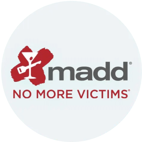 The image shows the MADD (Mothers Against Drunk Driving) logo with a red X behind a white martini glass. Next to it, the text reads: madd NO MORE VICTIMS.