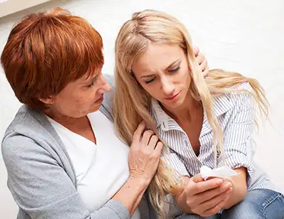 A woman looking at a phone.