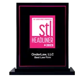A black and pink award plaque reads stl HEADLINER 2023 and OnderLaw, LLC Best Law Firm.
