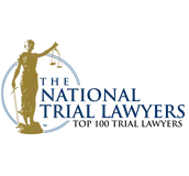 Logo of The National Trial Lawyers featuring a gold silhouette of Lady Justice holding scales, inside a blue circular outline, with the organizations name written in blue capital letters to the right.