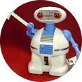 Toy robot with a white body, blue arms, and red eyes, holding a white key against a red background.