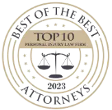 Gold seal badge with the text TOP 10 Personal Injury Law Firm in the center and Attorney and Practice Magazine around the outer edge.
